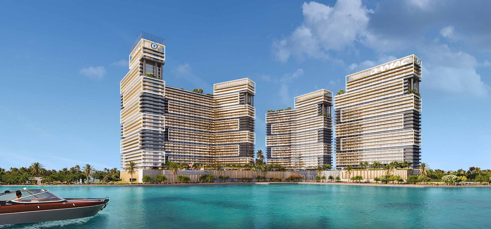 Chelsea Residences seen from the water: the towers of the campus above a waterfront promenade.