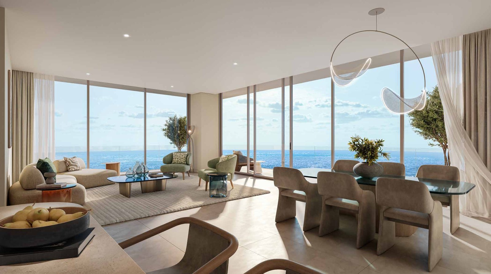 A living and dining room with floor-to-ceiling glass facing open sea.
