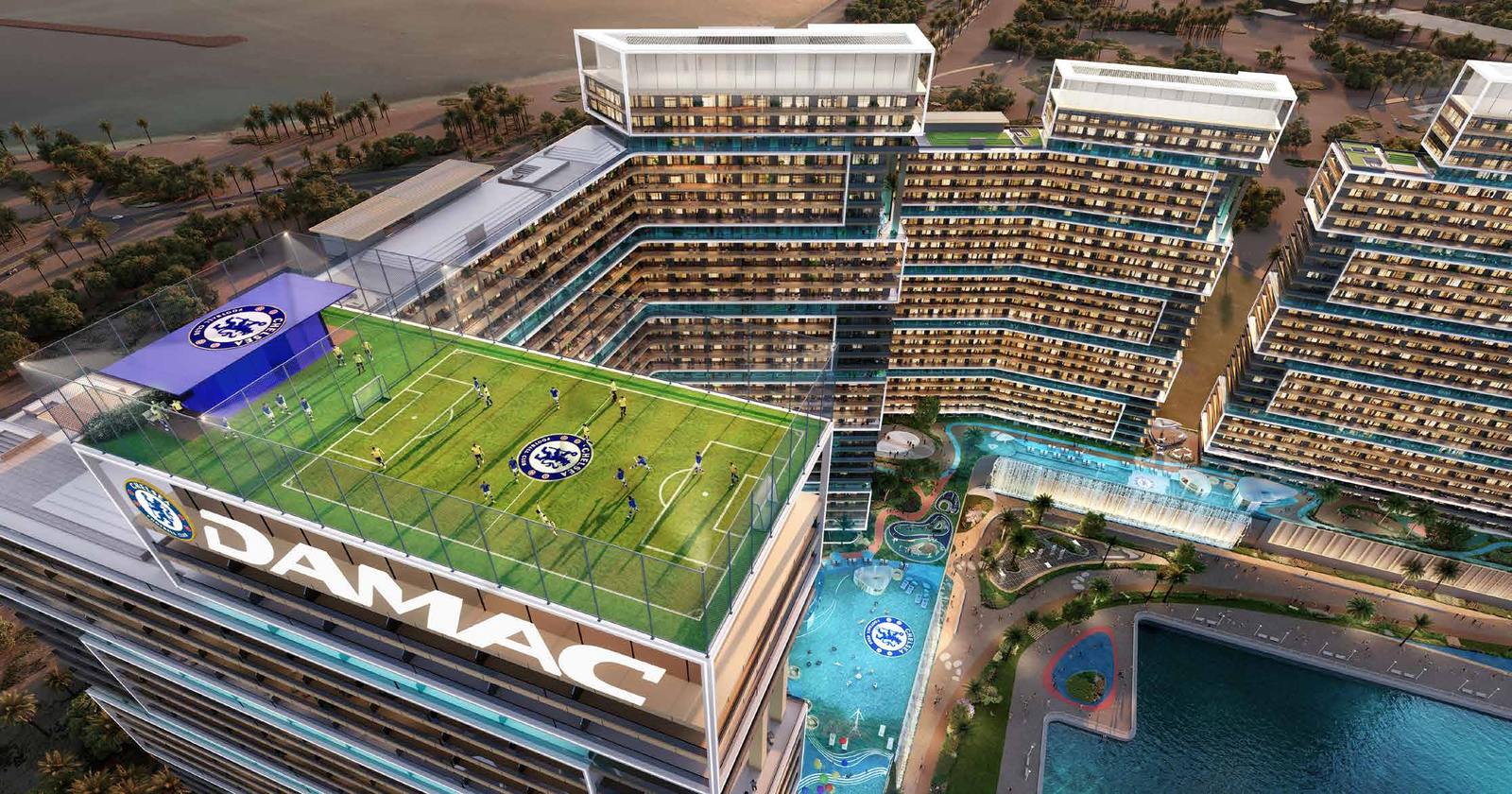 A rooftop football pitch and pool deck above the campus, the sea beyond.