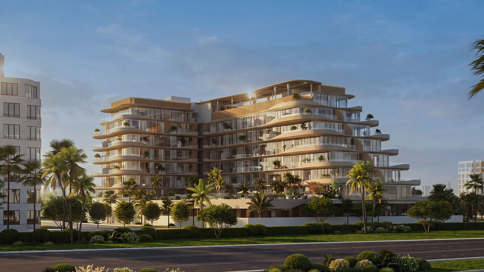Rabdan Avenue from the street: seven residential floors of curved white balconies above a landscaped podium.