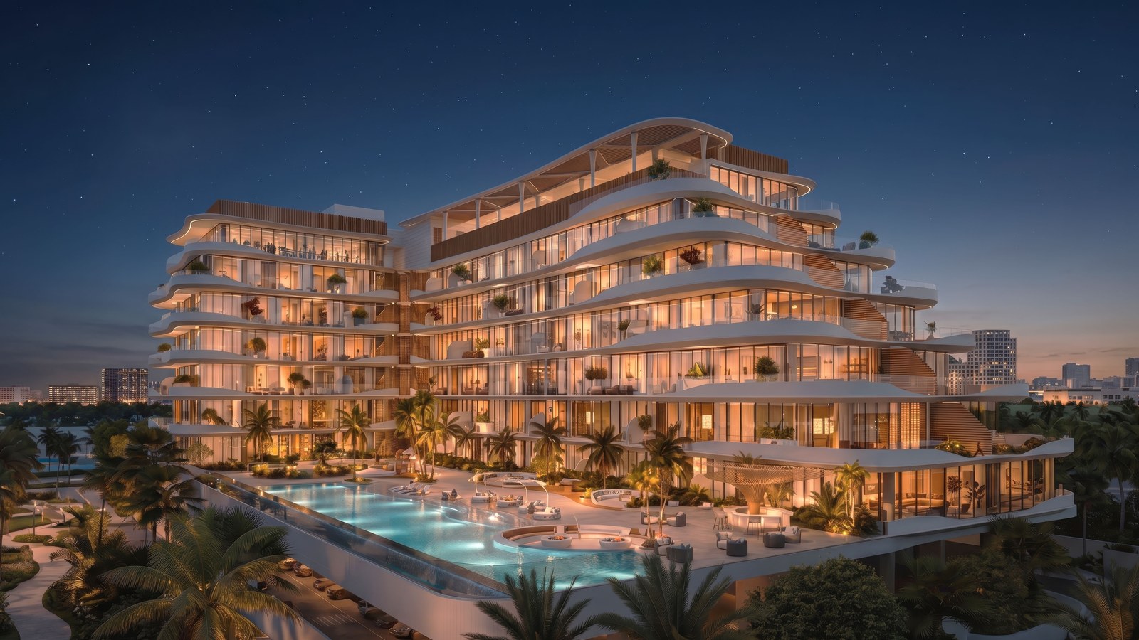 Rabdan Avenue at night: lit balconies above the podium pool.