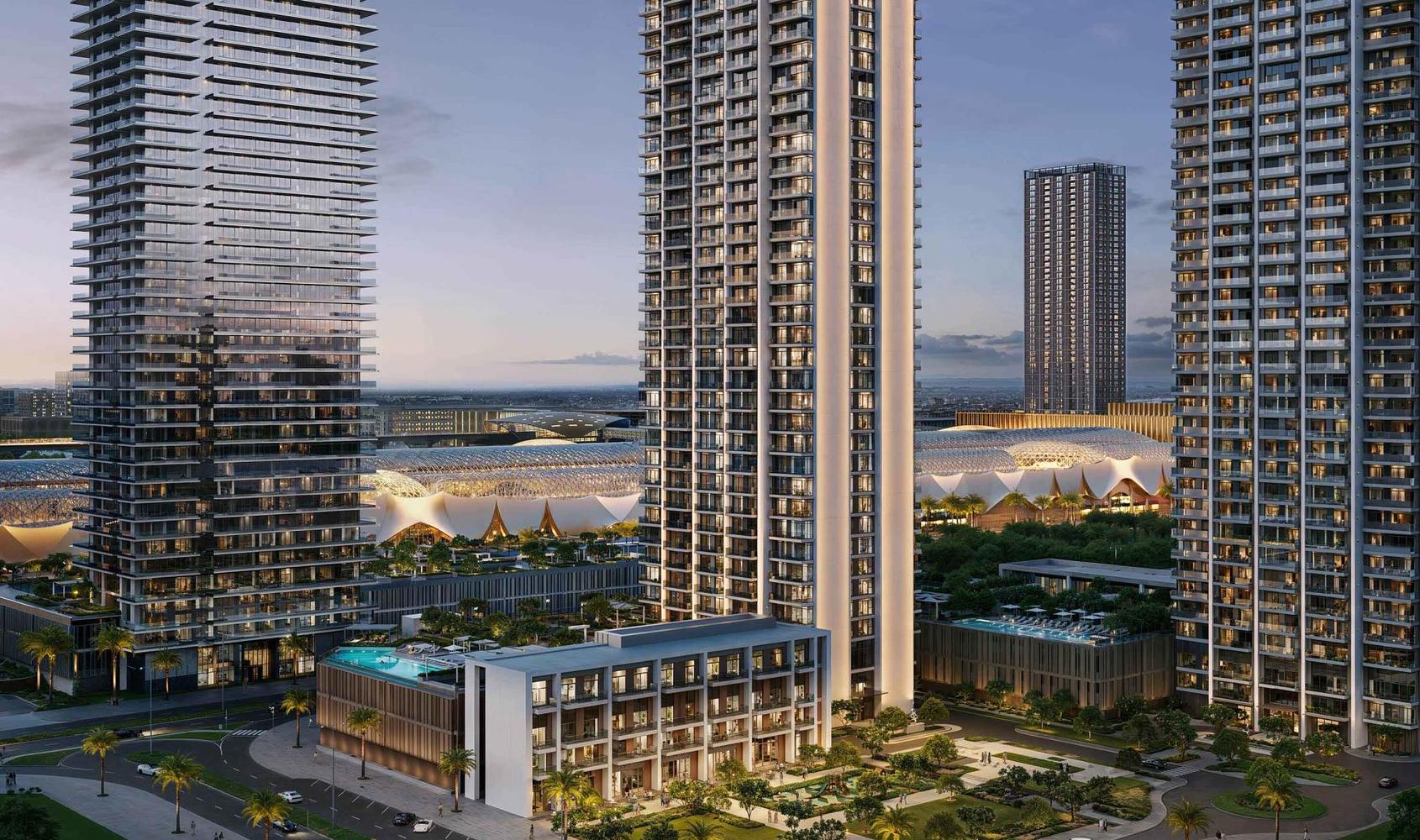 Valia at Dubai Creek Harbour: a slender residential tower with a three-storey clubhouse and pool at its foot, the Dubai Square canopies behind.